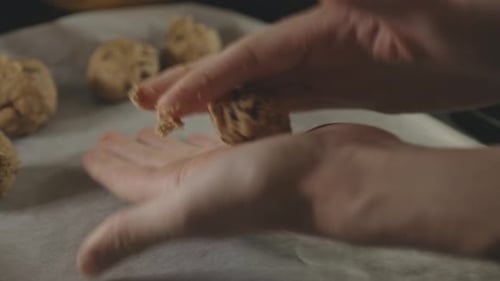 Hands Rolling Cookie Dough And Placing On Tray With Baking Sheet - close up