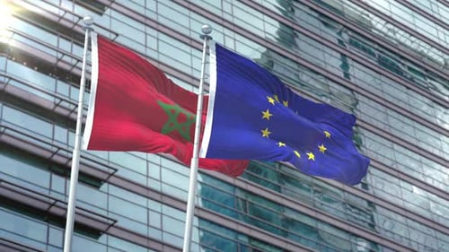 Morocco And European Union Flags Waving On Flagpoles