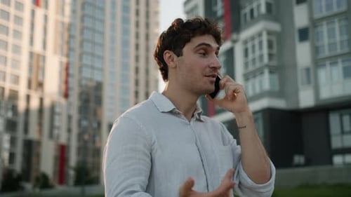 Man Talking on Phone in City
