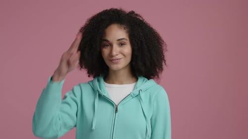 Smiling Woman Waving and Gesturing in Studio