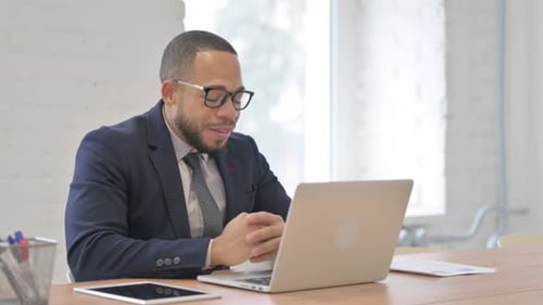 Man in Suit Having Positive Video Call