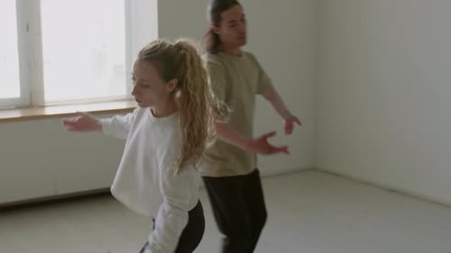 Couple of Ballet Dancers Rehearsing in Studio