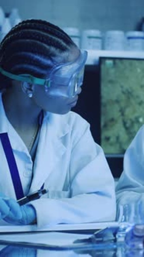 Scientists work in blue laboratory
