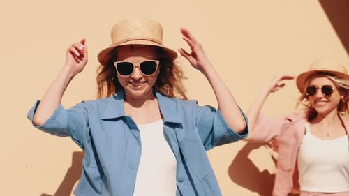 Two beautiful women posing in the street