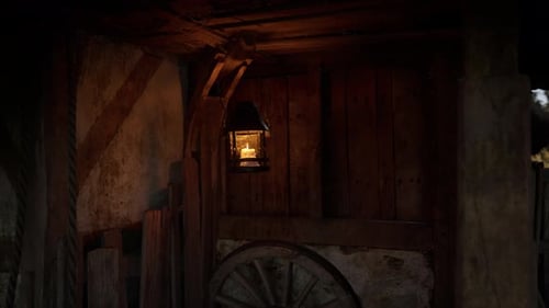 Flickering Candle Lantern in Rustic Setting