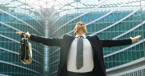Businessman Celebrating Success Outside Modern Office Building