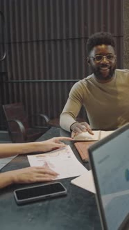 Man Talking with Team on Business Meeting in Cafe