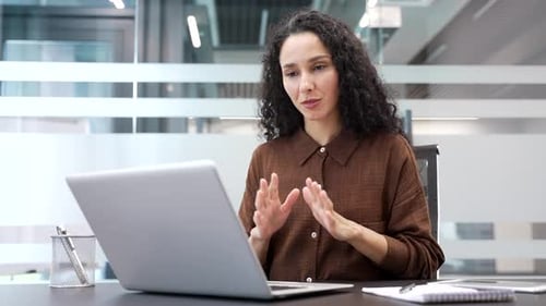 Woman Talking During Video Conference in Modern Office