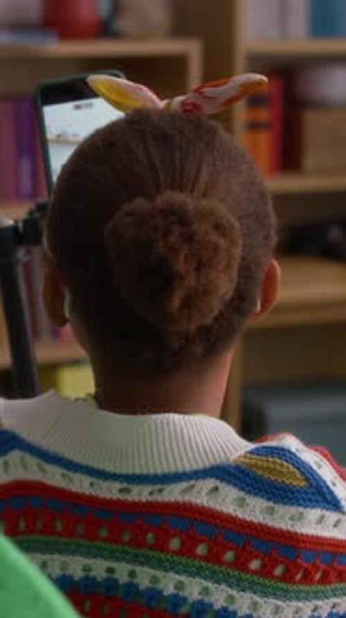 Child Interacting with Phone on Tripod