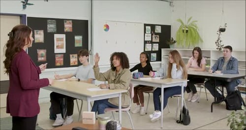 Student Learning in School Class Room. High School or College Class Raising Hand Asking Questions