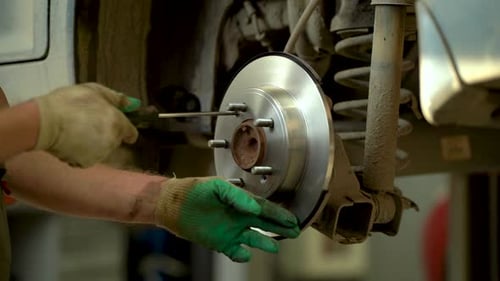 Mechanic Installing New Brake Discs on a Vehicle