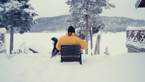 Person and Dog in Snowy Winter Landscape