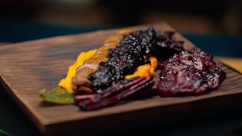 close-up of a dish pieces of juicy roasted duck with puree on a plate Asian cuisine restaurant