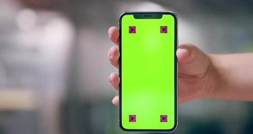 4k video footage of an unrecognizable person holding a mobile phone with a green screen