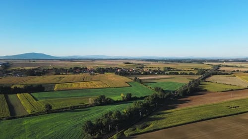 Aerial View of Rural Landscape with Fields Small Village and Mountains