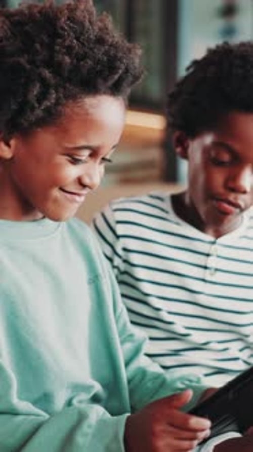 Two Boys Using Tablet Indoors