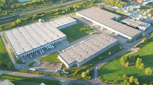 Aerial view of goods warehouse. Logistics center in industrial city zone from above. Aerial view of