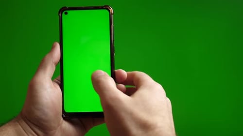 35a. Green screen smartphone scrolling sideways in hand on green background.