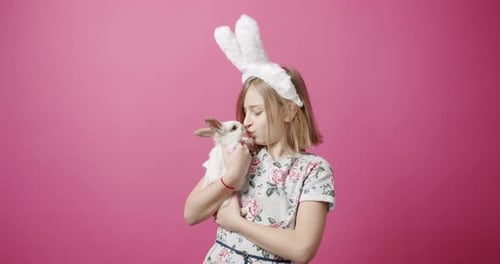 Girl Holding White Rabbit Wearing Bunny Ears