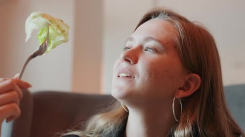 Closeup of Woman Savoring Crunchy Lettuce with Pleasant Expression Centered Image of Woman