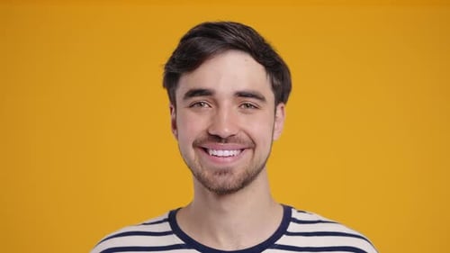 Smiling Young Man Portrait Against Yellow Background
