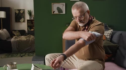 Senior Man Checking Blood Pressure at Home