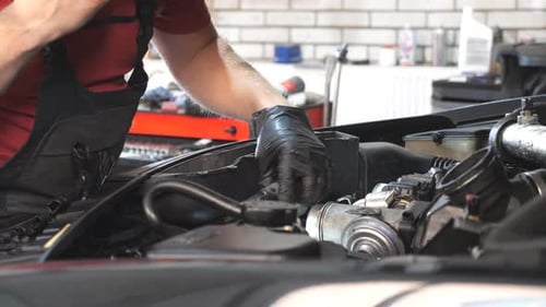 Mechanic Inspecting Car Engine at Auto Service Professional Repairman Working Under Hood of Vehicle