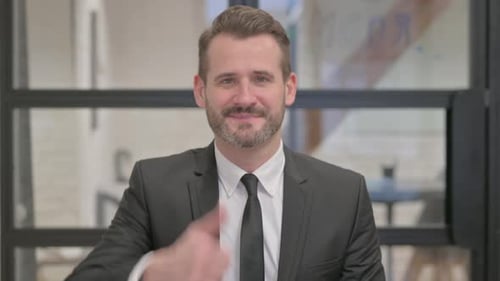 Man in Suit Gives Thumbs Up Gesture
