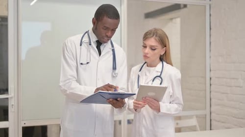 Two Healthcare Professionals Consult in Hospital Setting