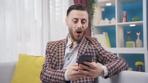 Man Using Smartphone Receives Good News