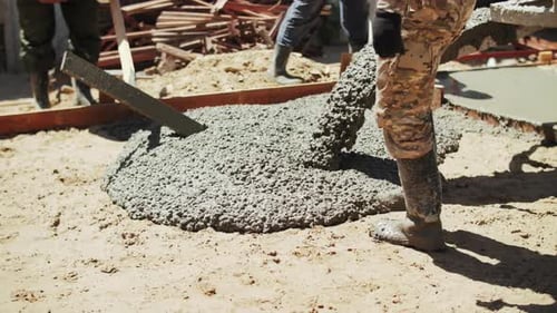 Builders Pour Concrete Into the Foundation