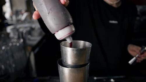Close-up - the process of preparing a cocktail in a restaurant using a shaker