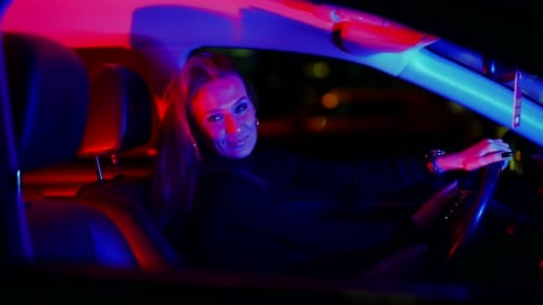 Stylish Woman in a Car at Night
