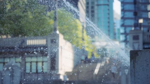 Water fountain splashing against the city background