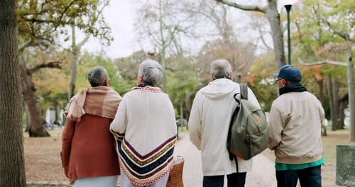 Nature, group and senior friends walking in an outdoor park for fresh air, exercise and bonding