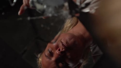 Desperate woman breaking a mirror with a rock. Slow motion close up