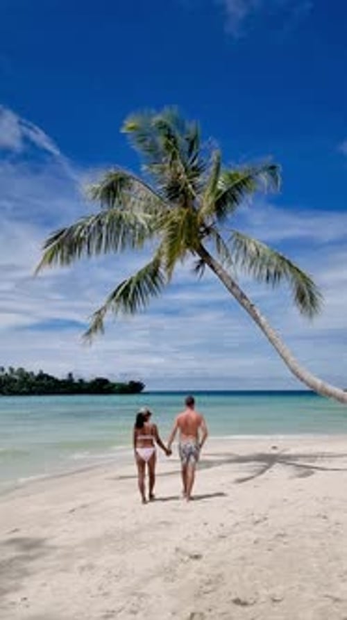 Couple Walking Hand in Hand Along the Pristine Beach of Koh Kood Thailand
