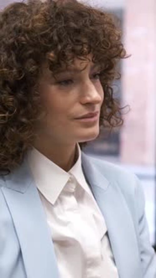 Woman in Blue Blazer Listening Attentively