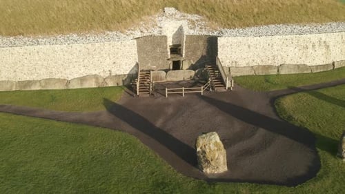 Upright Stones in Front Of Newgrange Entrance At Sunrise In County Meath, Ireland. - aerial shot