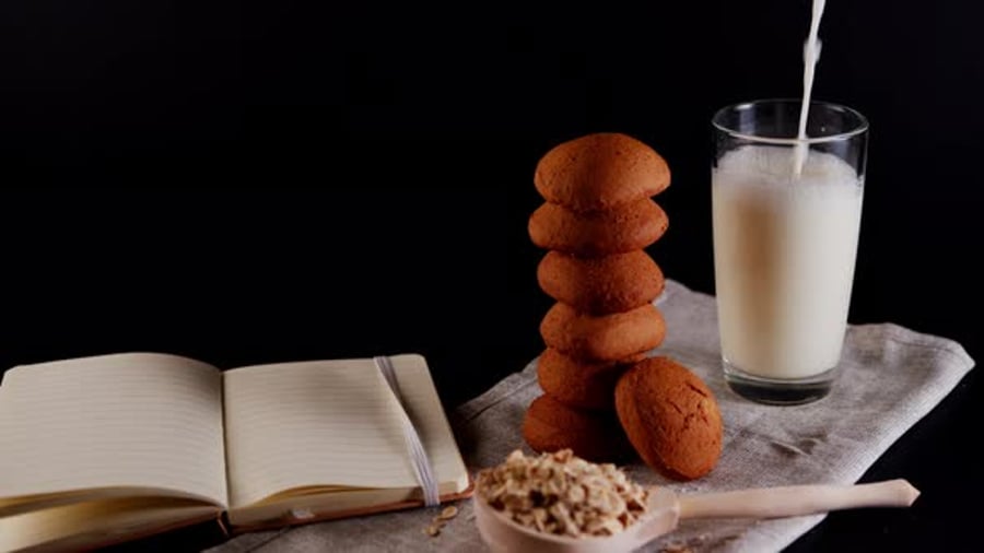 Stack of Fresh Oatmeal Cookies with Raw Oat Flakes in Large Wooden ...