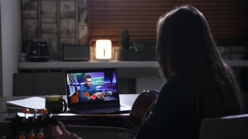 Guitar Lesson Online at Night in a Home
