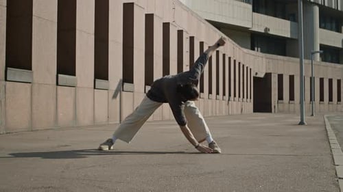 Man Warming Up with Stretching Exercise in City