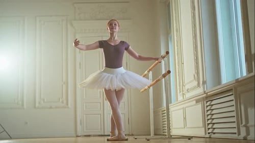 Ballerina Practicing at Barre in Bright Studio