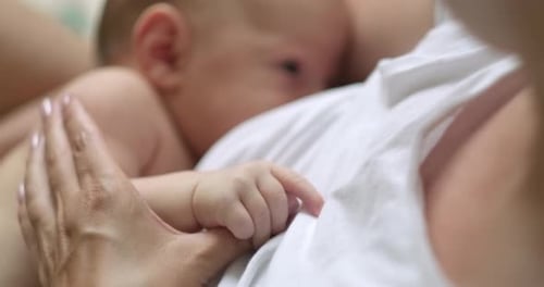 Young Mother Breastfeeds Her Newborn Baby at Home Cozy Footage Caring Togetherness Motherhood