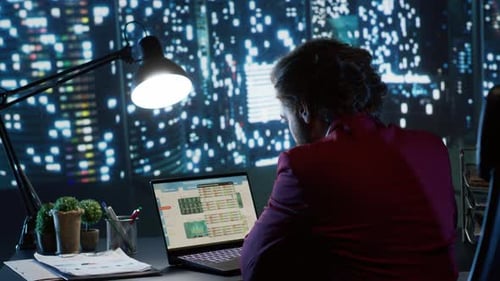 Economic Specialist Works on Financial Management at Desk