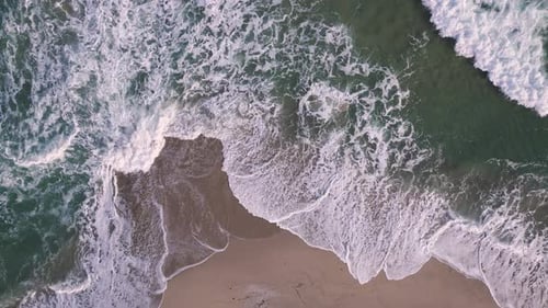 Aerial Top Down View on a Sandy Beach with Sea Surf Slow Motion Nobody