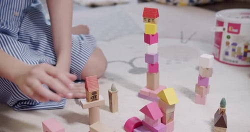 Children Play with Toys Sit on Floor Carpet at Home Game with Wooden Blocks