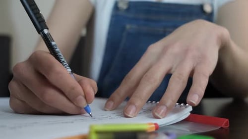 Young Adult Studying and Taking Notes