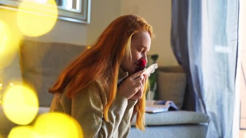 Woman Enjoys Small Handmade Object at Home