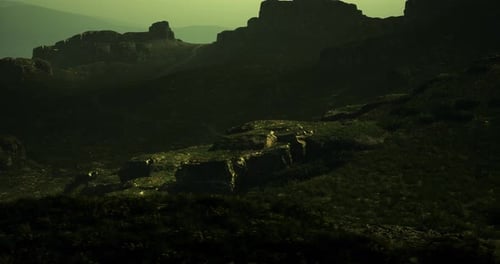 Landscape Featuring Rocky Formations in a Misty Atmosphere During Dusk